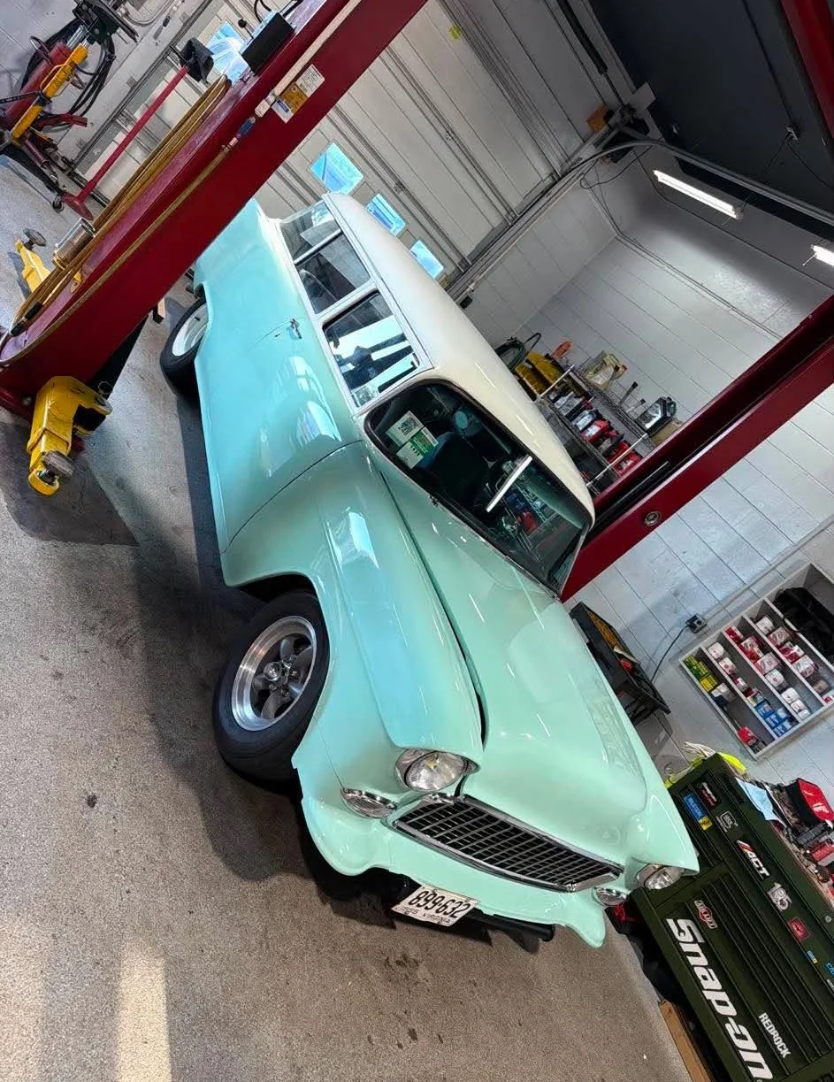Classic Chevy Wagon — Mint green classic Chevrolet Nomad or similar two-door station wagon on a two-post lift.