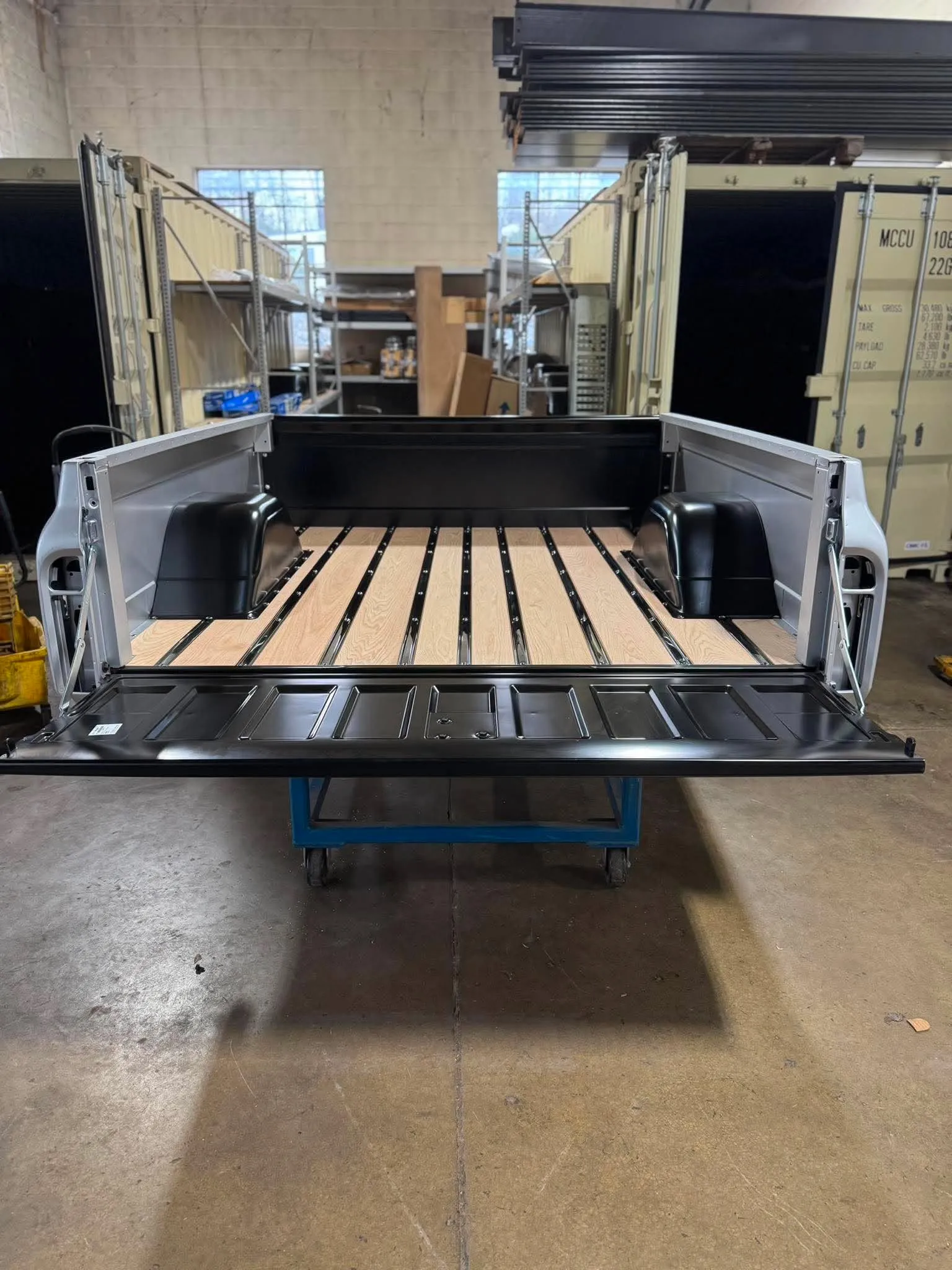 Truck Bed Restoration — Wide view of a restored classic truck bed with pristine wood slats inside the shop.