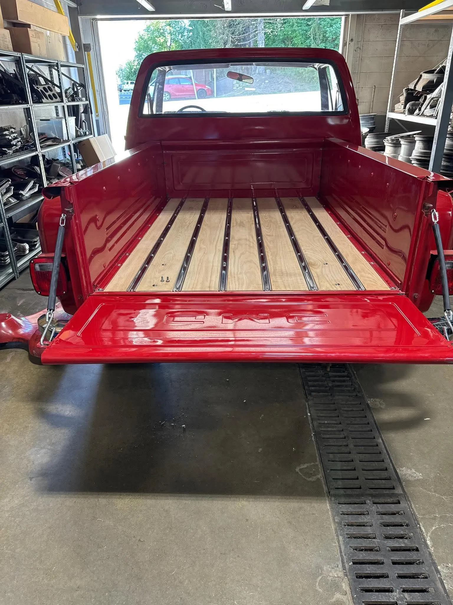 Red Classic Truck Bed — Rear view of a bright red classic GMC pickup truck showcasing a newly restored wood bed.